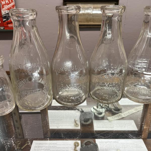 Five milk bottles from Deer Park Creamery (four quart bottles and one pint bottle)