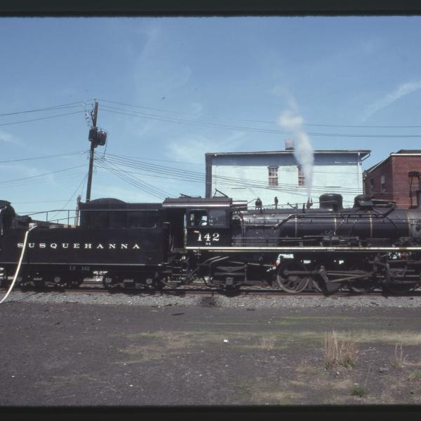 Photograph of Susquehanna 2-8-2 142 stopping for water in Port Jervis, NY, May 21, 1992