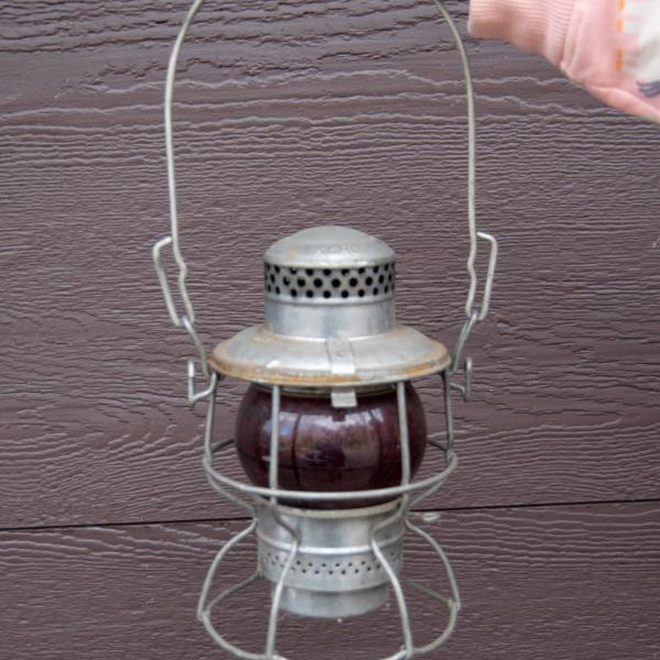Adlake lantern, marked EL with red unmarked globe