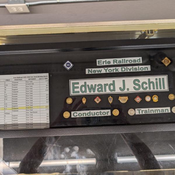 Boxed display of union and service pins from Edward J. Schill, Erie trainman and conductor