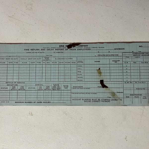 Pad of Erie Railroad time and delay report of train employees, unused, May 1958