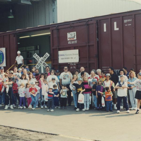 Photograph of Conrail employees and exterior of Conrail Safety on Rails Theater boxcar 368191 at Pavonia Yard, Camden, NJ, mid-1990s