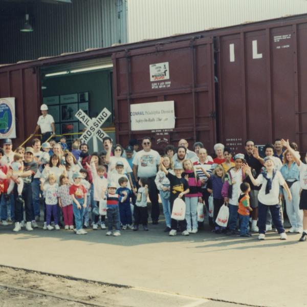 Photograph of Conrail employees and exterior of Conrail Safety on Rails Theater boxcar 368191 at Pavonia Yard, Camden, NJ, mid-1990s