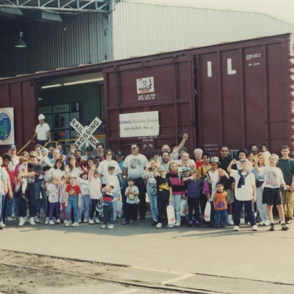 Photograph of Conrail employees and exterior of Conrail Safety on Rails Theater boxcar 368191 at Pavonia Yard, Camden, NJ, mid-1990s