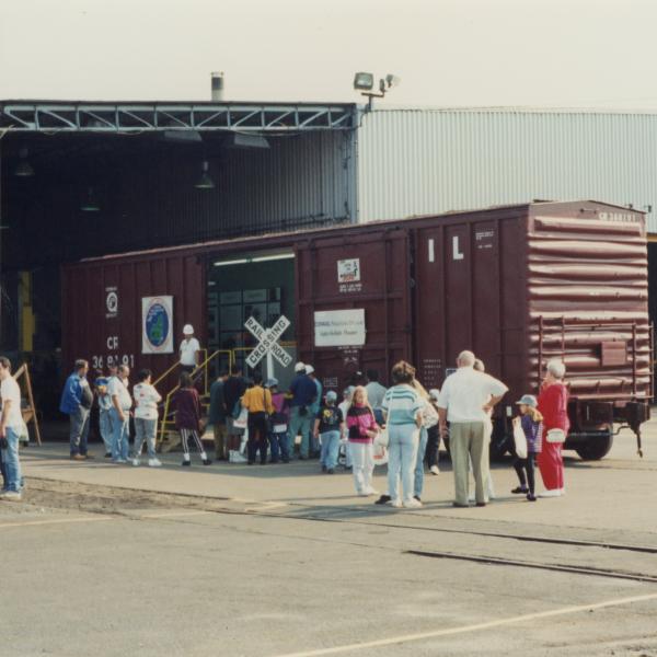 Photograph of Conrail employees and exterior of Conrail Safety on Rails Theater boxcar 368191 at Pavonia Yard, Camden, NJ, mid-1990s