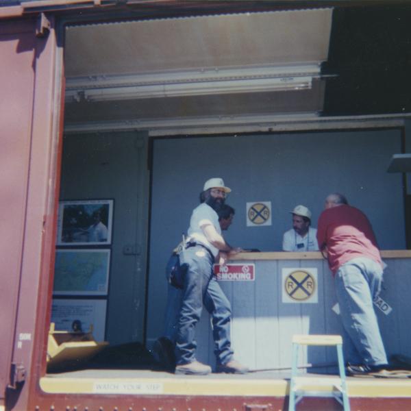 Photograph of exterior of Conrail Safety on Rails Theater boxcar 368191 and crew at Port Jervis, NY, July 1996