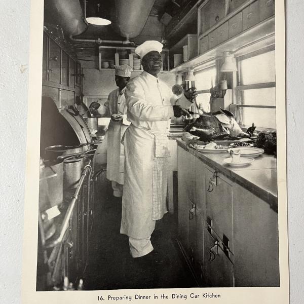 Photograph of chefs cooking in dining car kitchen