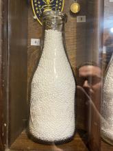 Five milk bottles from Deer Park Creamery (four quart bottles and one pint bottle)