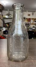 Two milk bottles from Moore's (one quart bottle and one pint bottle)