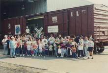 Photograph of Conrail employees and exterior of Conrail Safety on Rails Theater boxcar 368191 at Pavonia Yard, Camden, NJ, mid-1990s