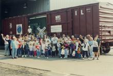 Photograph of Conrail employees and exterior of Conrail Safety on Rails Theater boxcar 368191 at Pavonia Yard, Camden, NJ, mid-1990s