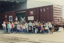 Photograph of Conrail employees and exterior of Conrail Safety on Rails Theater boxcar 368191 at Pavonia Yard, Camden, NJ, mid-1990s