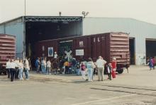 Photograph of Conrail employees and exterior of Conrail Safety on Rails Theater boxcar 368191 at Pavonia Yard, Camden, NJ, mid-1990s