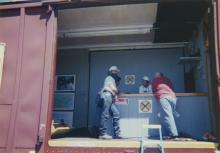 Photograph of exterior of Conrail Safety on Rails Theater boxcar 368191 and crew at Port Jervis, NY, July 1996