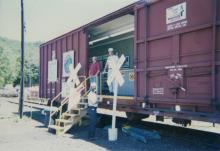Photograph of exterior of Conrail Safety on Rails Theater boxcar 368191 and crew at Port Jervis, NY, July 1996