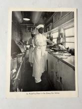 Photograph of chefs cooking in dining car kitchen